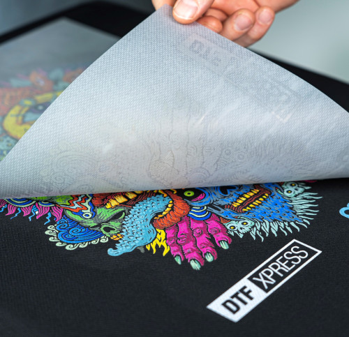Close-up of a custom UV DTF transfer design on a black T-shirt.